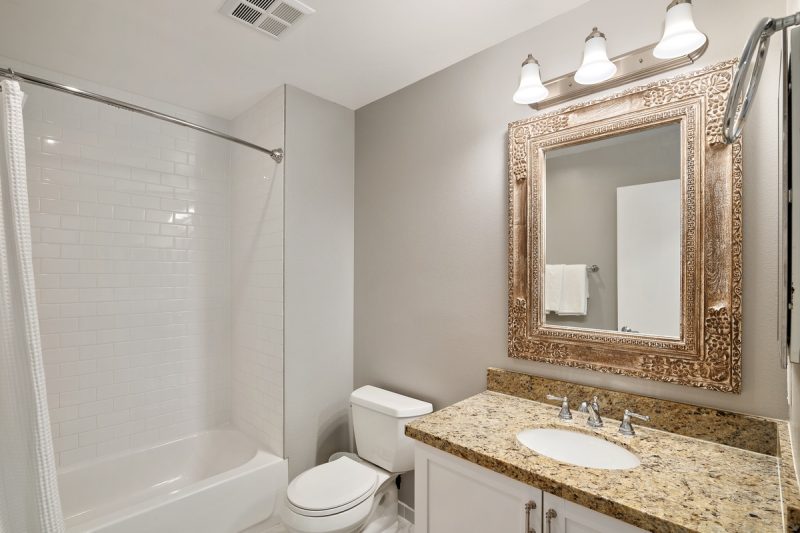 Guest bathroom with stylish mirror.