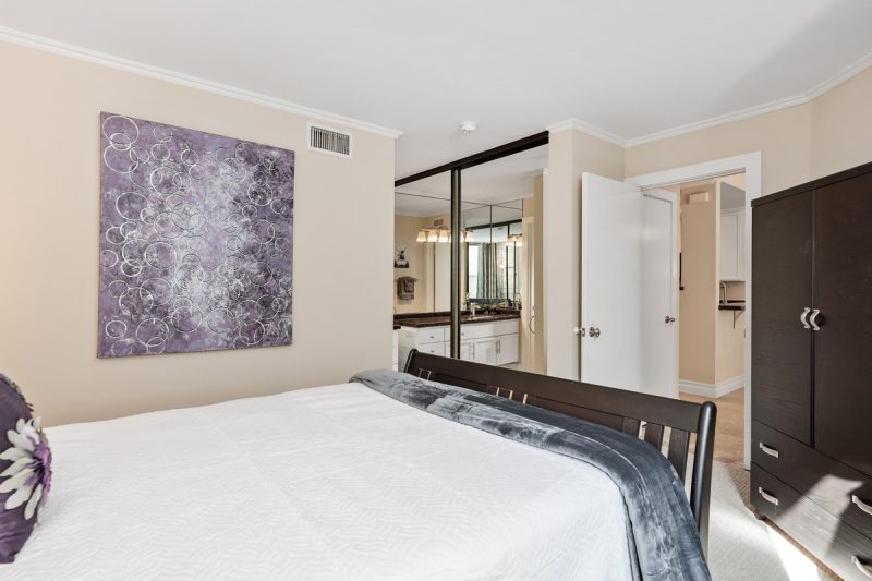 Ample storage space in the bedroom, with a wardrobe and a large sliding door closet.