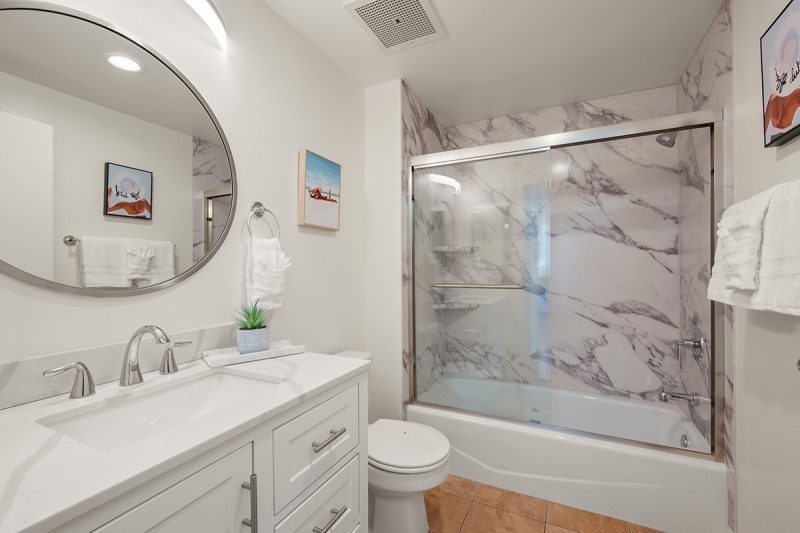 Primary bathroom with a combined shower-bathtub.