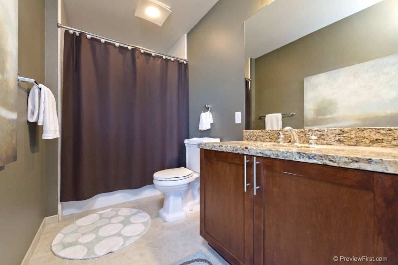 Master bathroom with combined shower-bathtub.