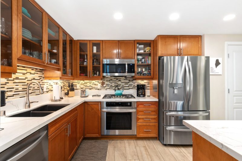 Kitchen with updated, stainless steel appliances.