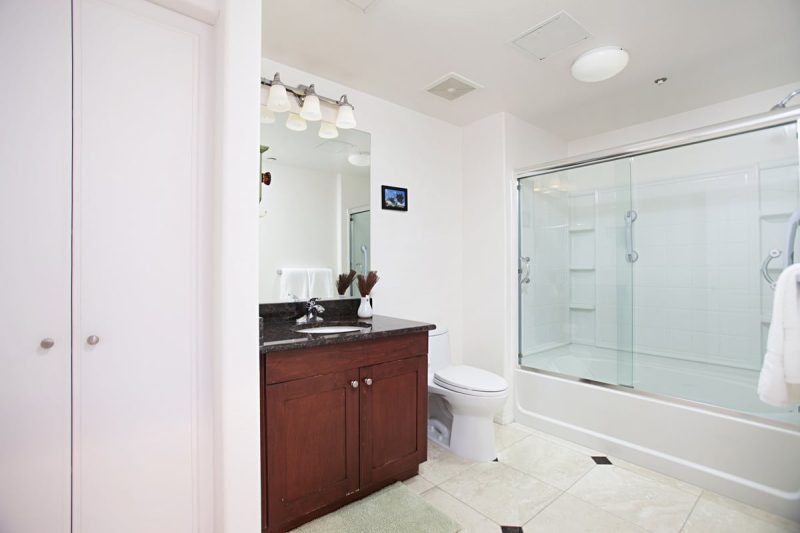 Guest bathroom with combination shower-bathtub.