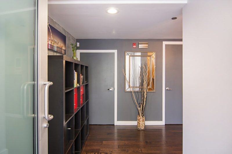 Entryway area with a shelving unit.