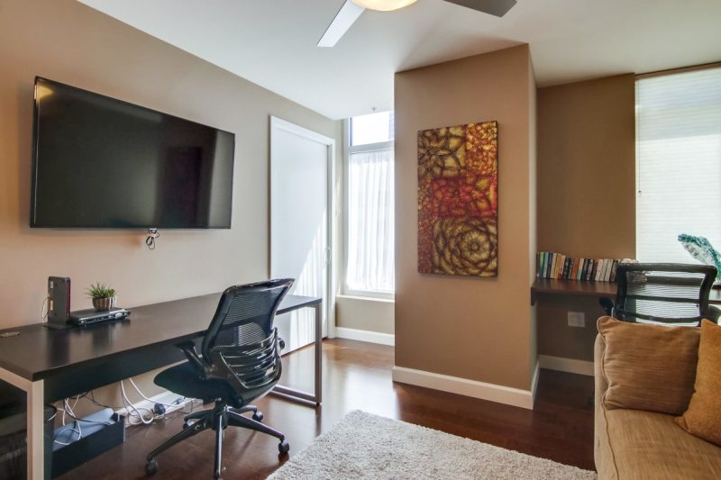 Large Smart TV and two convenient workspaces in the guest bedroom.