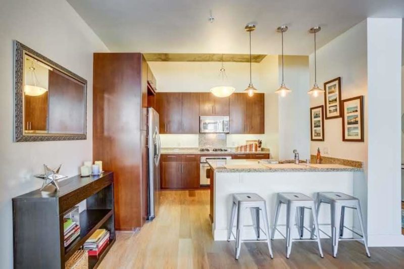 Three barstools offer seating at the kitchen counter.
