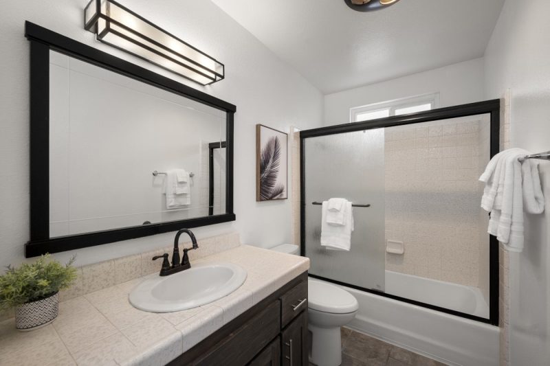 Combined shower-bathtub in the primary bathroom.
