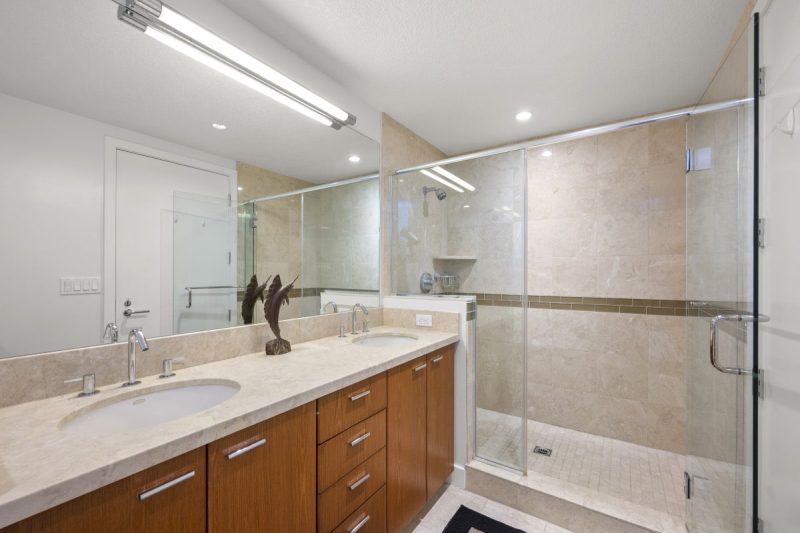 Master bathroom with freestanding bathtub, dual sinks and walk-in shower.