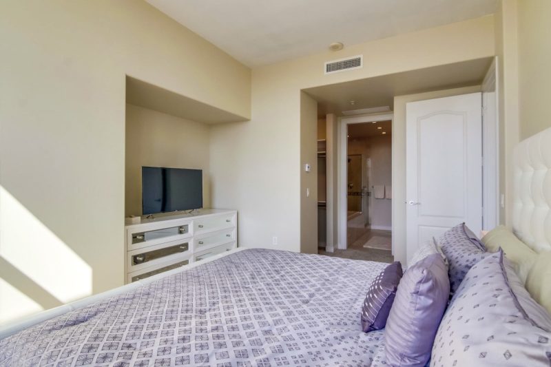 Large Smart TV and walk-in closet in the master bedroom.